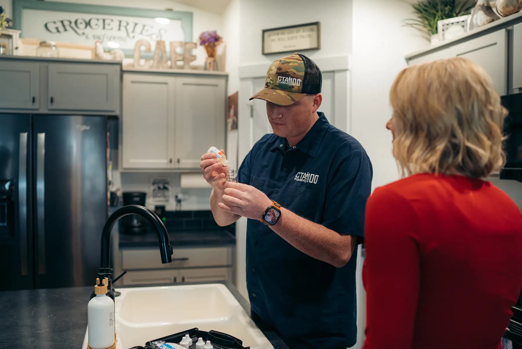 CTA Plumbing 100 technician explaining plumbing work to a customer