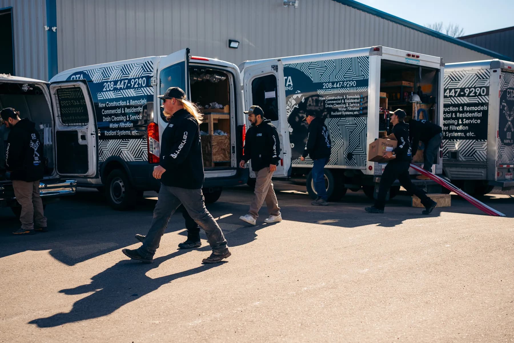 CTA Plumbing 100 team beside a branded service vehicle